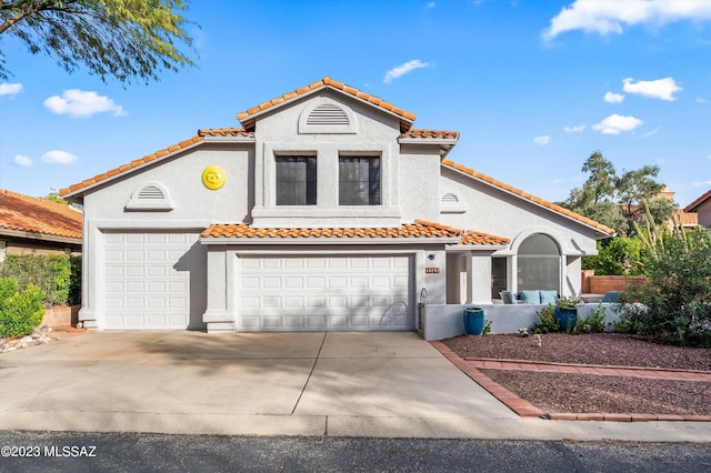 mediterranean / spanish house featuring a garage