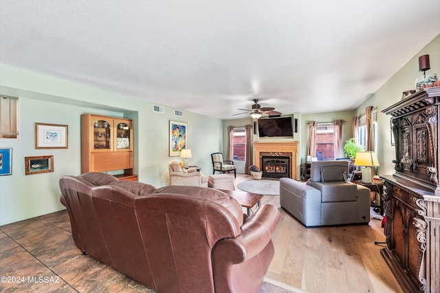 living room featuring ceiling fan and dark hardwood / wood-style floors