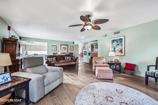 living room with light wood-type flooring and ceiling fan