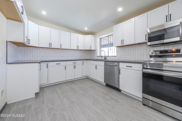 kitchen with white cabinets, stainless steel appliances, and sink