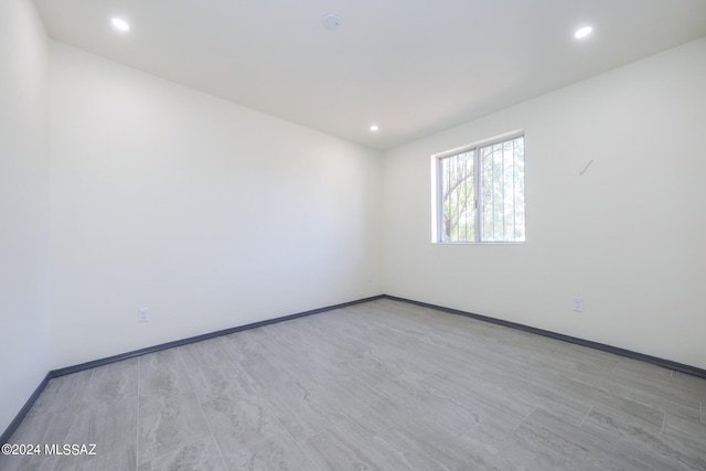 spare room with light hardwood / wood-style flooring