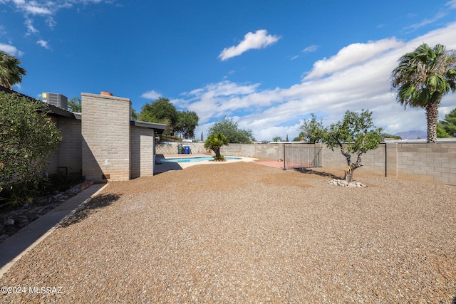 view of yard with a fenced in pool