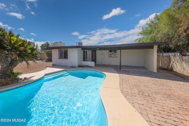 view of swimming pool with a patio