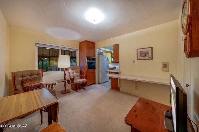 sitting room featuring light colored carpet