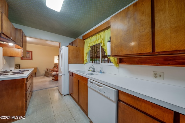 kitchen with light tile patterned flooring, sink, and white appliances