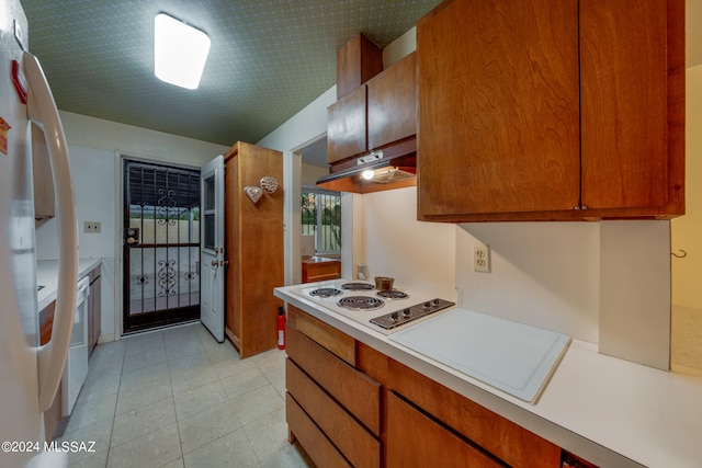 kitchen featuring white appliances and light tile patterned flooring