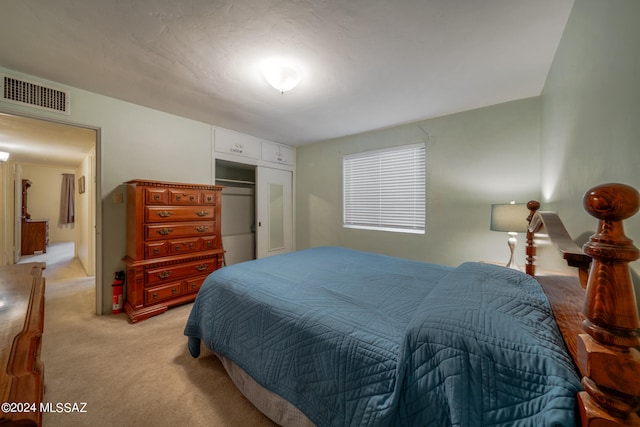 carpeted bedroom with a closet