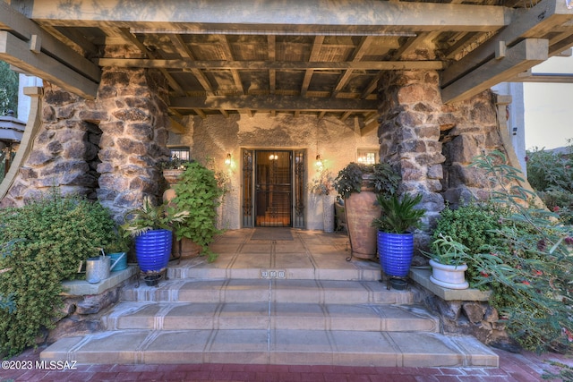 property entrance featuring a patio