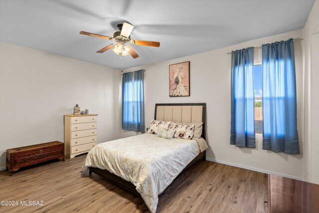 bedroom with ceiling fan and light hardwood / wood-style flooring