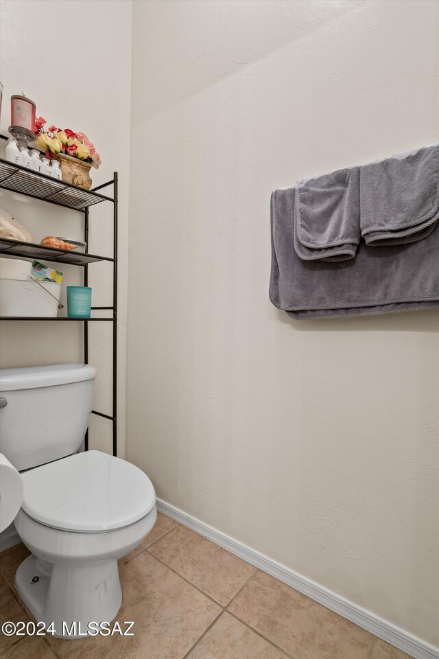 bathroom with tile patterned flooring and toilet