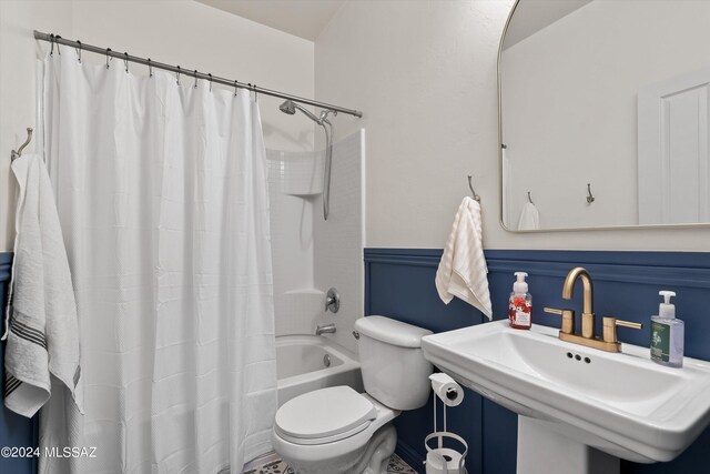 full bathroom with toilet, sink, and shower / bath combo