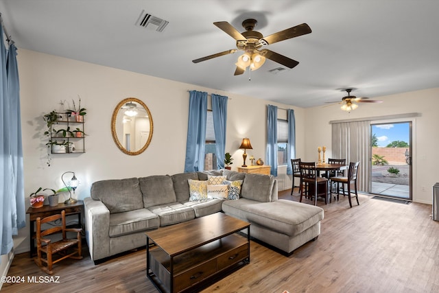 living room featuring hardwood / wood-style flooring and ceiling fan