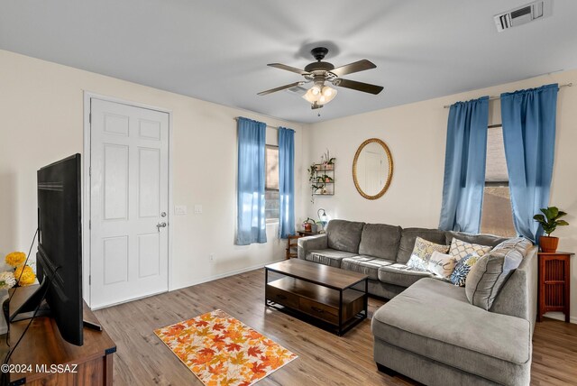 living room with ceiling fan and light hardwood / wood-style floors