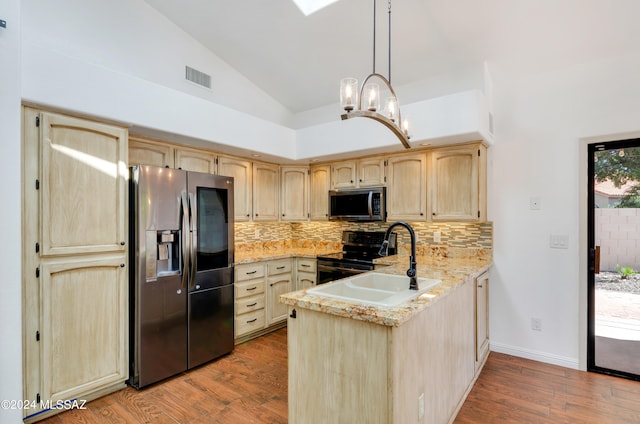 kitchen with hanging light fixtures, sink, dark wood-type flooring, stainless steel appliances, and light brown cabinetry