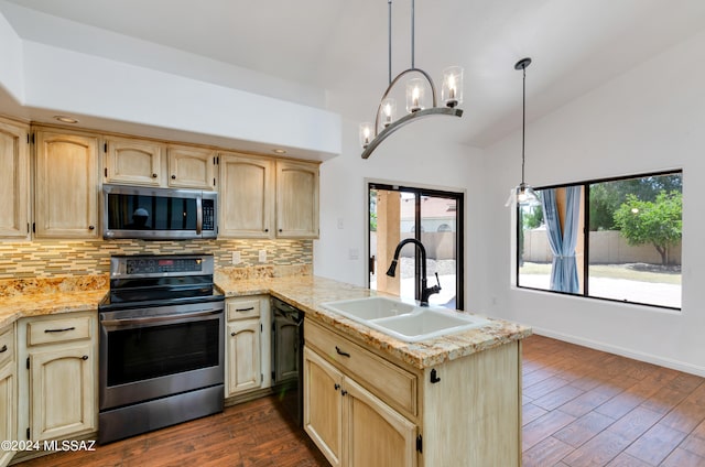 kitchen featuring pendant lighting, appliances with stainless steel finishes, dark wood-type flooring, and sink