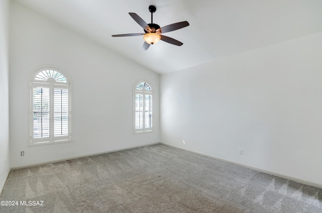 unfurnished room with light carpet, lofted ceiling, and plenty of natural light