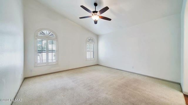 unfurnished room with carpet flooring, vaulted ceiling, and ceiling fan