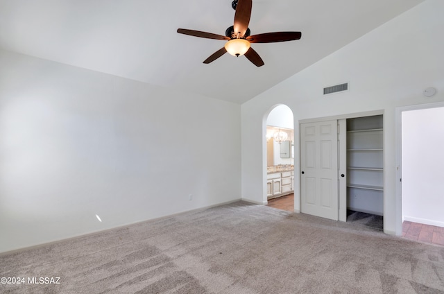 unfurnished bedroom with light carpet, ceiling fan, ensuite bath, and a closet