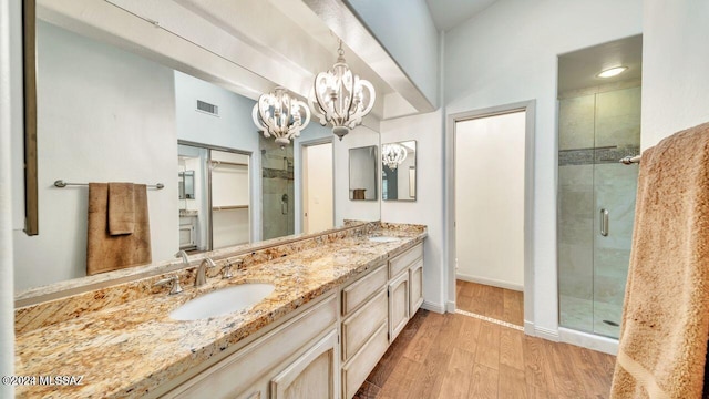 bathroom with vanity, hardwood / wood-style flooring, and an enclosed shower