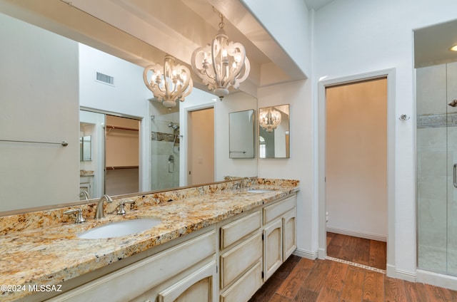 bathroom featuring hardwood / wood-style flooring, vanity, and an enclosed shower