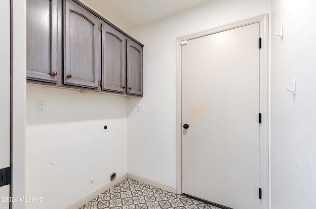 washroom with hookup for an electric dryer and cabinets