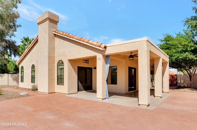 rear view of property with a patio and ceiling fan