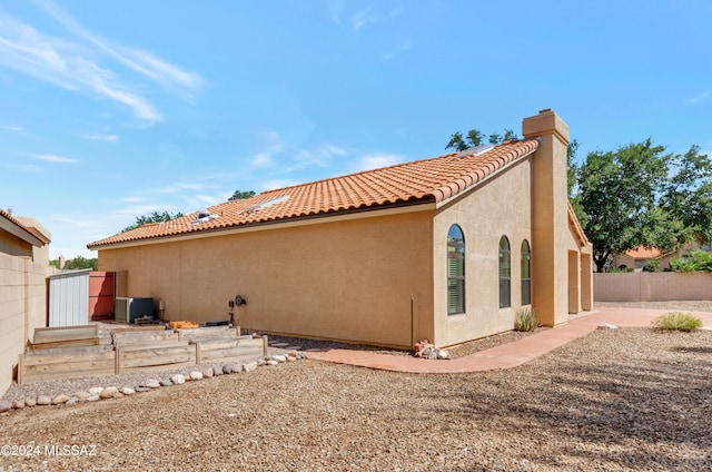 rear view of property featuring central AC unit