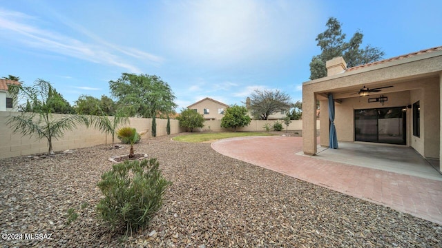 view of yard featuring a patio and ceiling fan