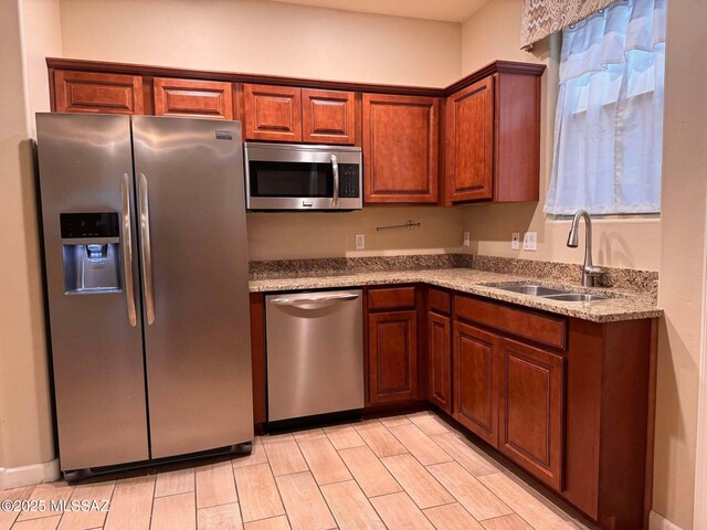 kitchen featuring stainless steel appliances and light hardwood / wood-style flooring