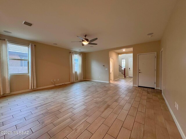 carpeted home office featuring ceiling fan