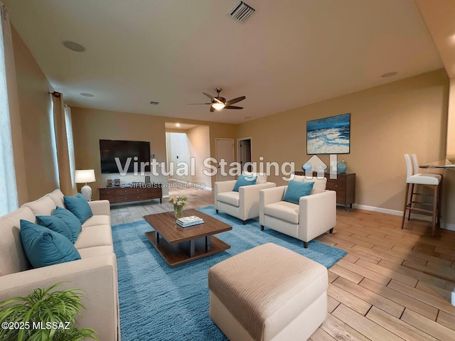 living room with ceiling fan, baseboards, visible vents, and wood finish floors