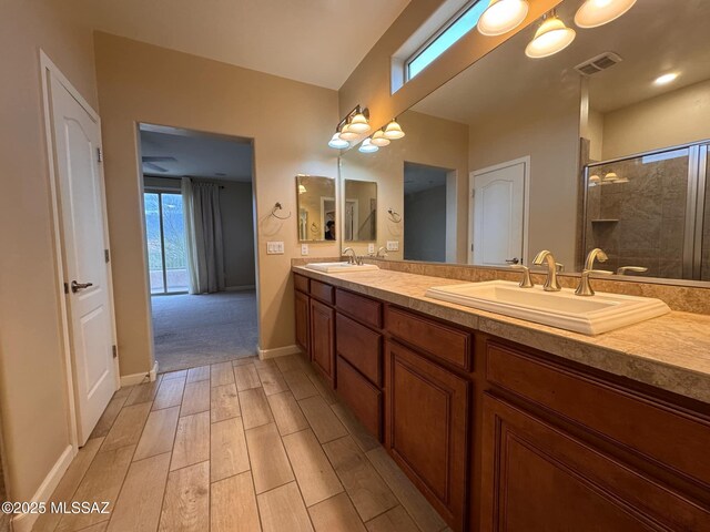 bathroom with walk in shower, vanity, and toilet