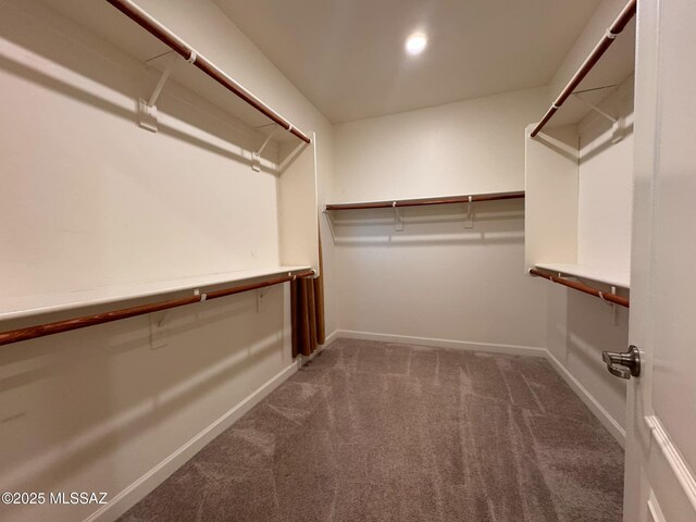 kitchen with stainless steel appliances, sink, light hardwood / wood-style flooring, and light stone counters