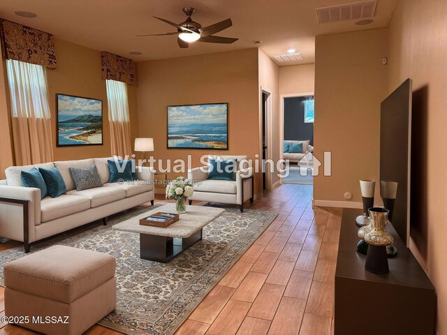 living room with ceiling fan and light hardwood / wood-style flooring