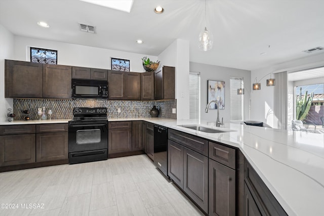 kitchen featuring pendant lighting, sink, tasteful backsplash, dark brown cabinetry, and black appliances