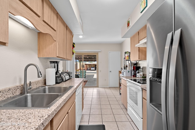 kitchen with white appliances, light brown cabinetry, sink, and light tile patterned flooring