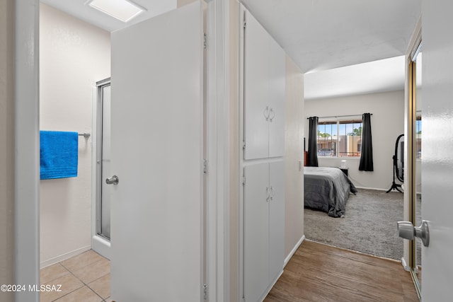 hallway with light colored carpet