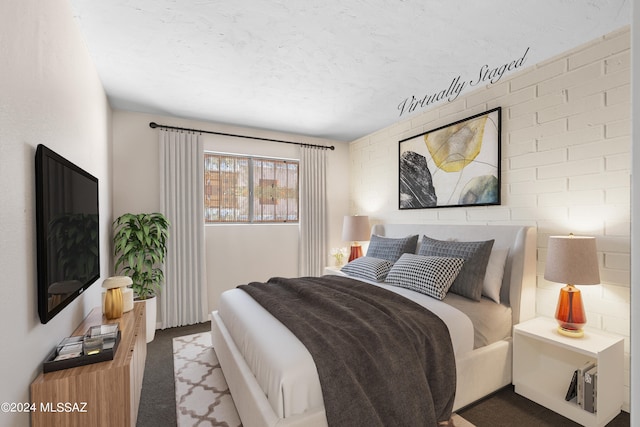 bedroom featuring light colored carpet and a textured ceiling