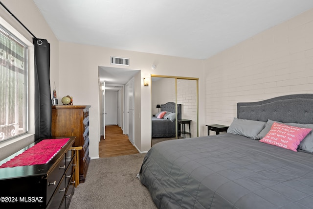 bedroom with hardwood / wood-style floors and a closet