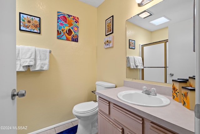 bathroom featuring a shower with door, vanity, toilet, and tile patterned floors