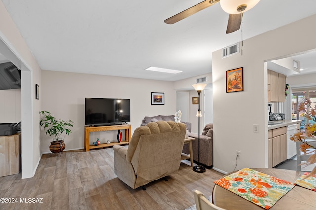 living room with ceiling fan and light wood-type flooring