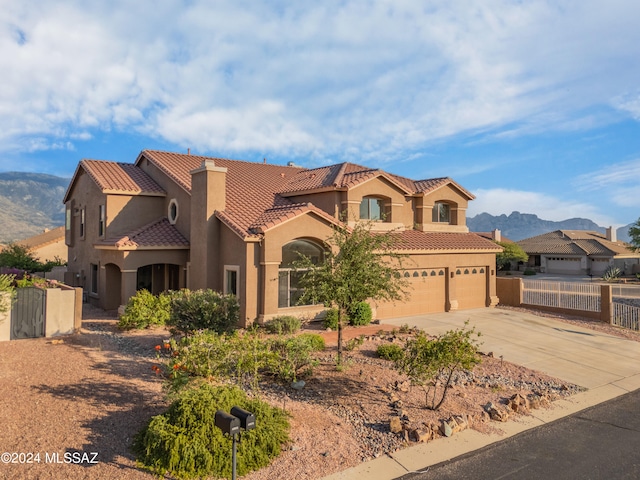 mediterranean / spanish-style house with a mountain view and a garage