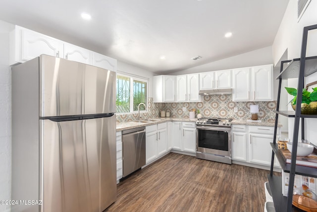 kitchen with dark hardwood / wood-style floors, stainless steel appliances, sink, lofted ceiling, and white cabinets