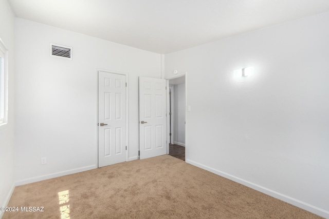 unfurnished bedroom with light colored carpet