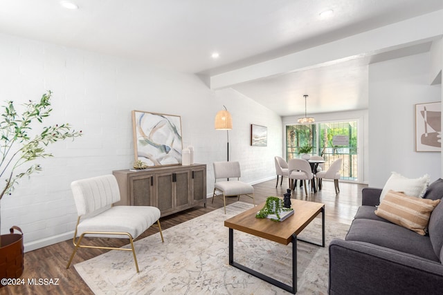 living room with hardwood / wood-style flooring and lofted ceiling with beams