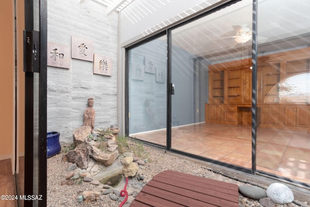 interior space with ceiling fan