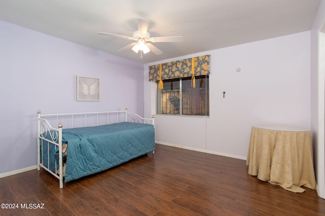 bedroom with dark wood-type flooring and ceiling fan