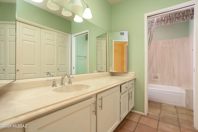 bathroom with tile patterned floors, bathing tub / shower combination, and vanity