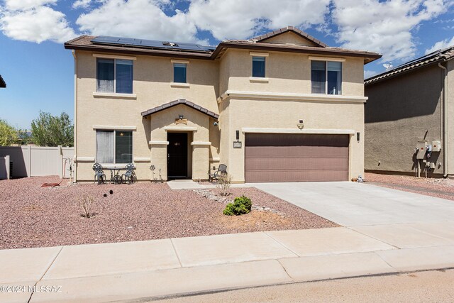 view of front of house with a garage and solar panels