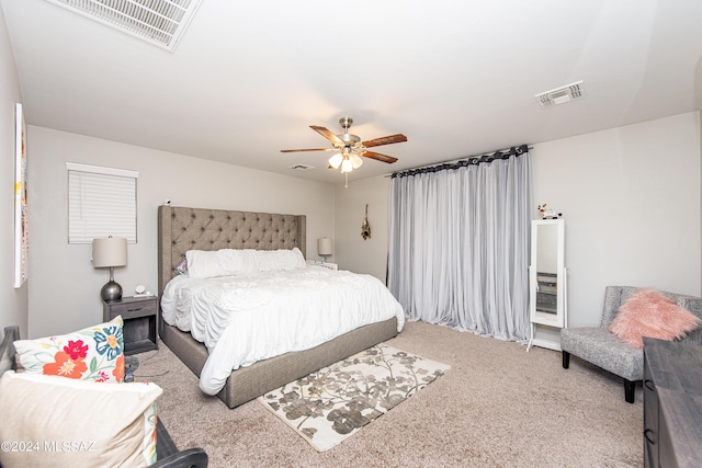 bedroom featuring visible vents, ceiling fan, and carpet flooring